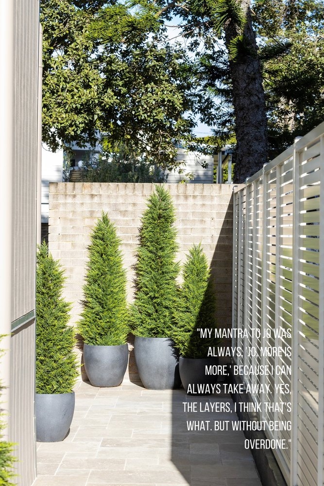 Book page: potted conifers against a pale brick courtyard wall